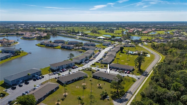 birds eye view of property with a water view and a residential view