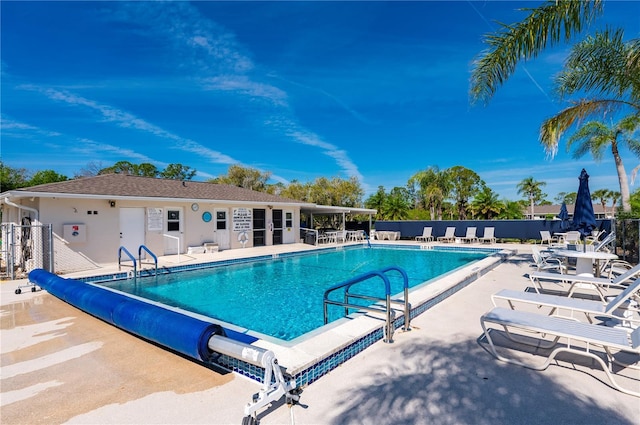 pool with fence and a patio