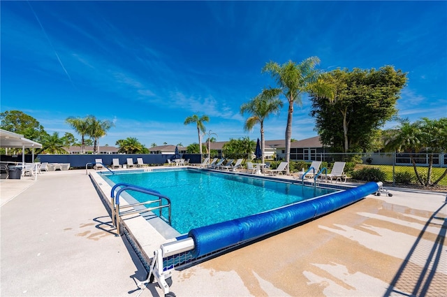 pool featuring a patio area and fence