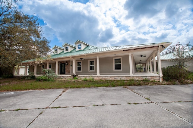 farmhouse inspired home with metal roof and a porch