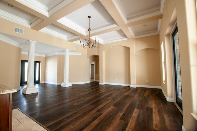 empty room with ornate columns, dark wood-style floors, visible vents, and coffered ceiling