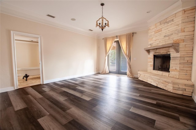 unfurnished living room featuring ornamental molding, dark wood-type flooring, a fireplace, and visible vents