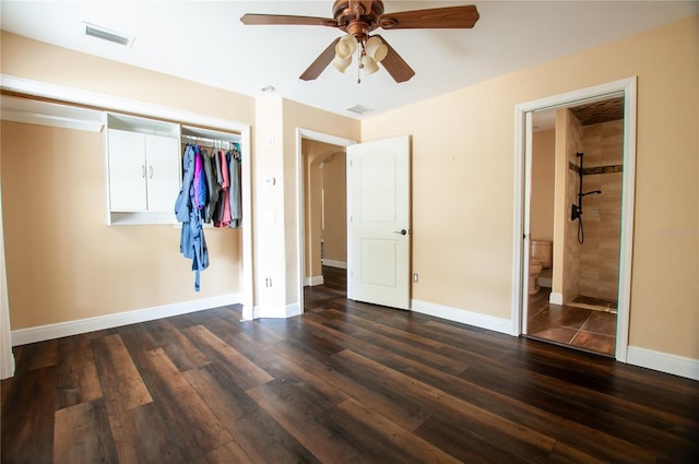 unfurnished bedroom featuring a closet, visible vents, dark wood finished floors, and baseboards