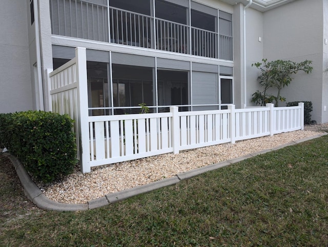 view of side of property featuring a sunroom and stucco siding