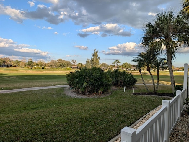 view of home's community featuring a yard and fence