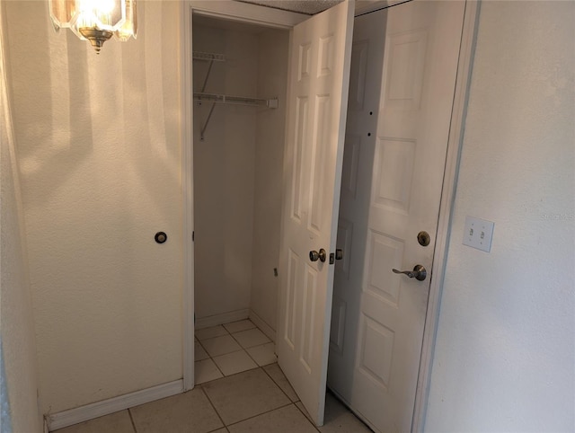 interior space with tile patterned flooring and baseboards