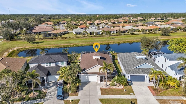 birds eye view of property featuring a water view and a residential view