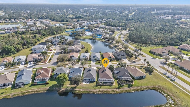 drone / aerial view featuring a residential view and a water view