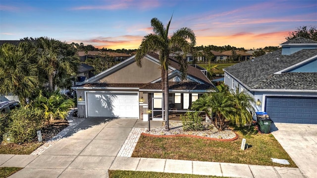 view of front of property with an attached garage, concrete driveway, and stucco siding