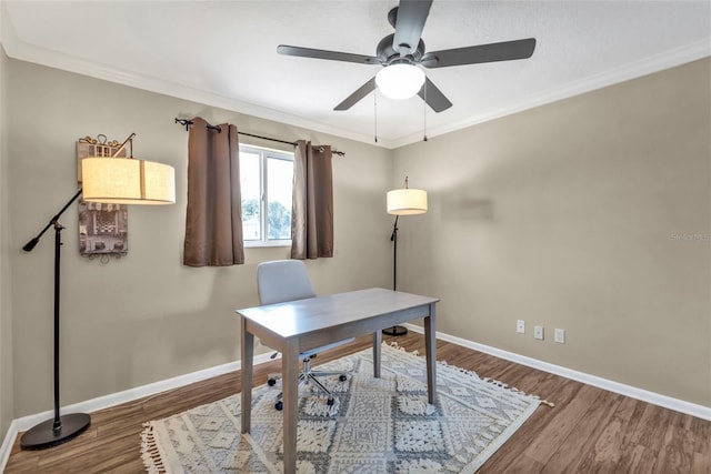 home office featuring baseboards, ceiling fan, wood finished floors, and crown molding