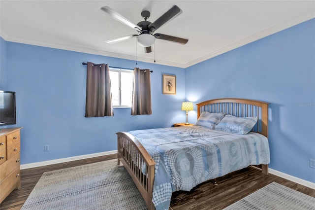 bedroom featuring a ceiling fan, dark wood finished floors, baseboards, and ornamental molding