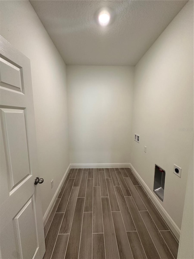 washroom featuring wood tiled floor, electric dryer hookup, a textured ceiling, laundry area, and baseboards