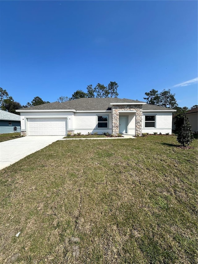 view of front of house with stucco siding, driveway, stone siding, a front yard, and a garage