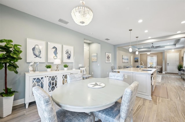 dining room featuring light wood-style floors, visible vents, baseboards, and recessed lighting