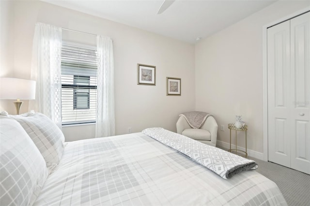 bedroom with ceiling fan, carpet floors, a closet, and baseboards