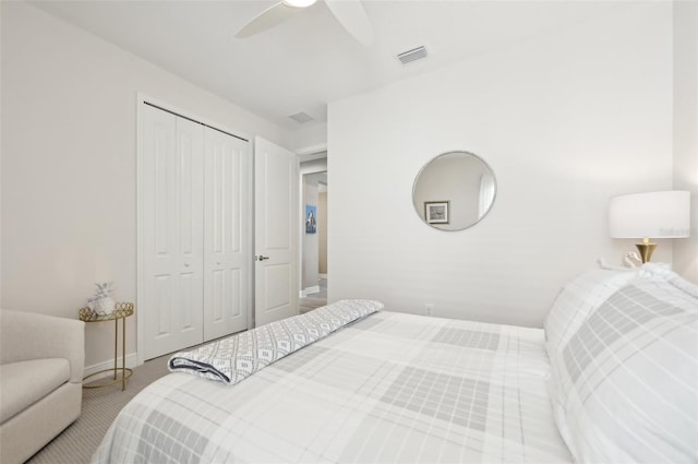 bedroom featuring baseboards, visible vents, ceiling fan, carpet flooring, and a closet