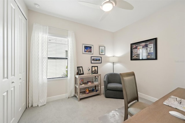 office space with a ceiling fan, carpet, and baseboards