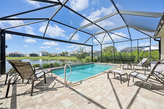 pool featuring a lanai, a patio area, a residential view, and a water view