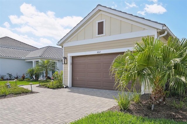 garage featuring decorative driveway