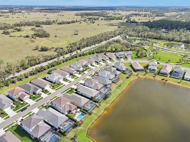 bird's eye view featuring a residential view and a water view