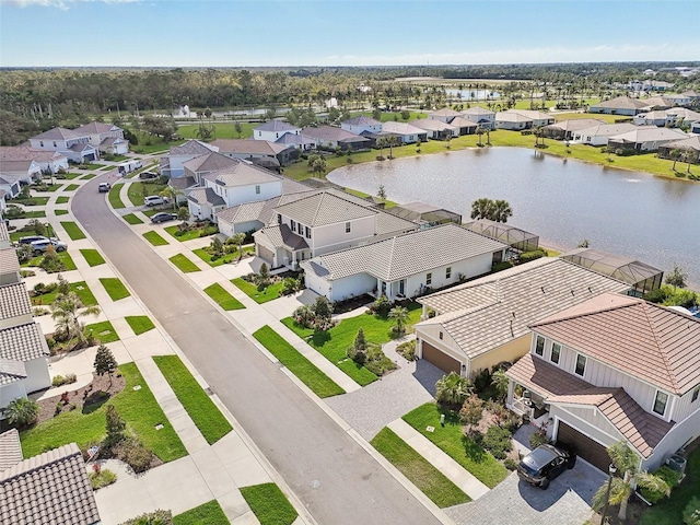 drone / aerial view featuring a water view and a residential view