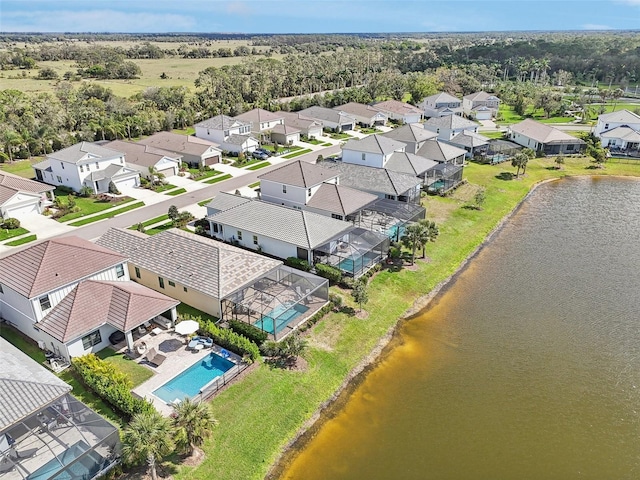 drone / aerial view featuring a water view and a residential view