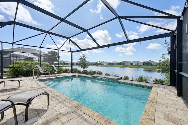 outdoor pool featuring a water view, glass enclosure, and a patio