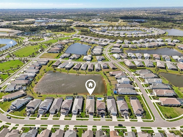 birds eye view of property featuring a water view and a residential view