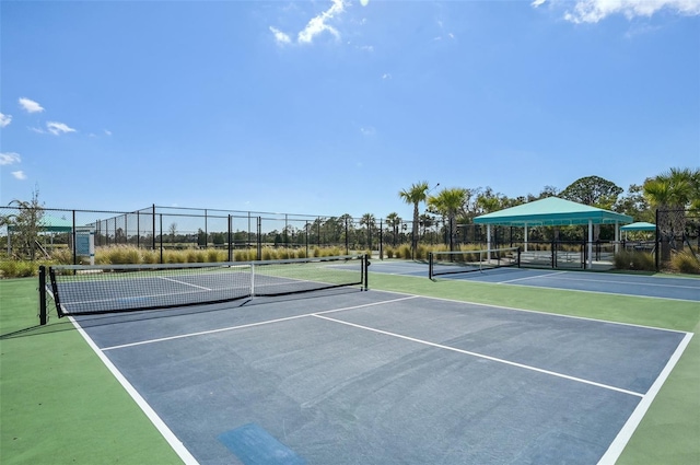 view of tennis court with fence