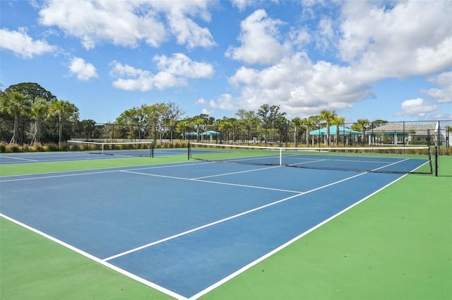 view of tennis court featuring fence