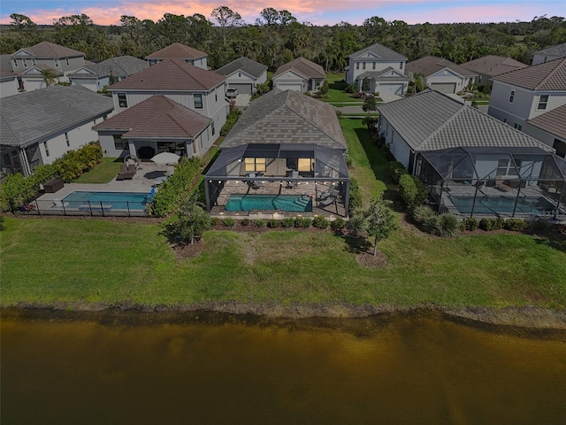 bird's eye view featuring a water view and a residential view