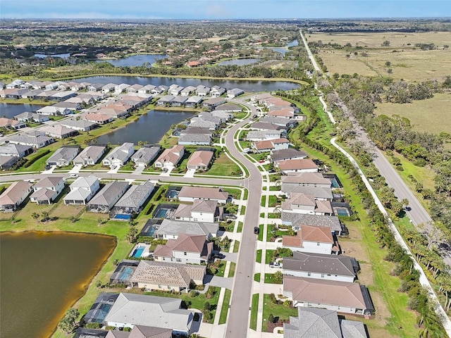 bird's eye view featuring a residential view and a water view