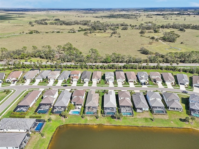 drone / aerial view featuring a water view and a residential view