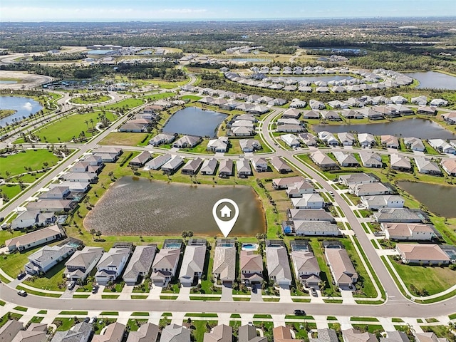 aerial overview of property's location with nearby suburban area and a nearby body of water