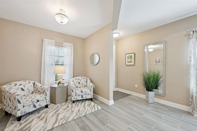 living area featuring wood tiled floors and baseboards