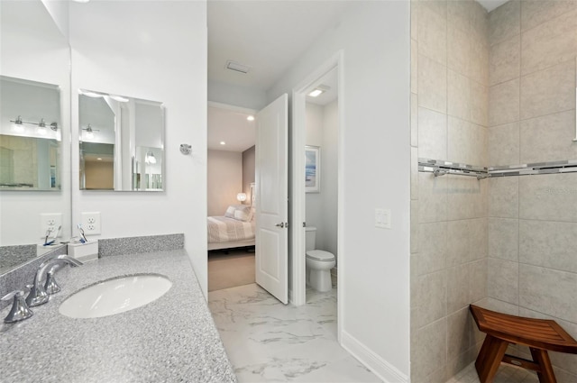 ensuite bathroom with toilet, marble finish flooring, vanity, baseboards, and recessed lighting
