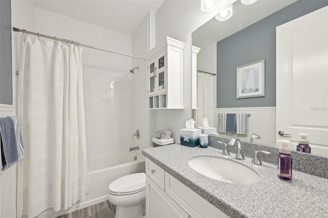 bathroom featuring vanity, shower / bath combo with shower curtain, and toilet