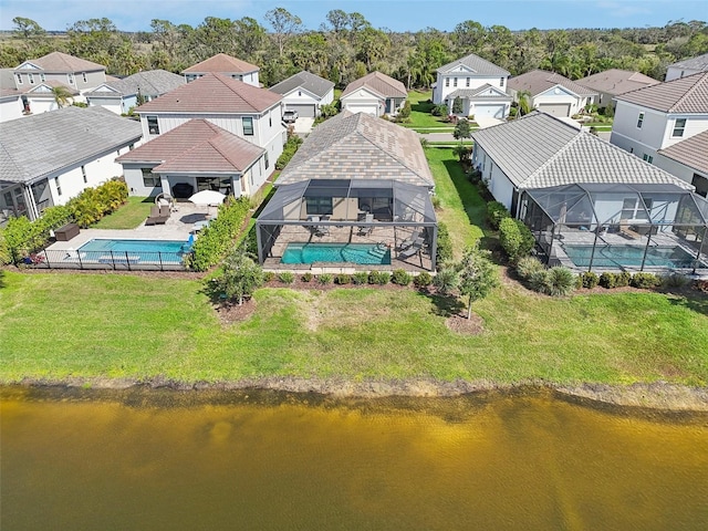 aerial view of residential area featuring a pool area and a nearby body of water