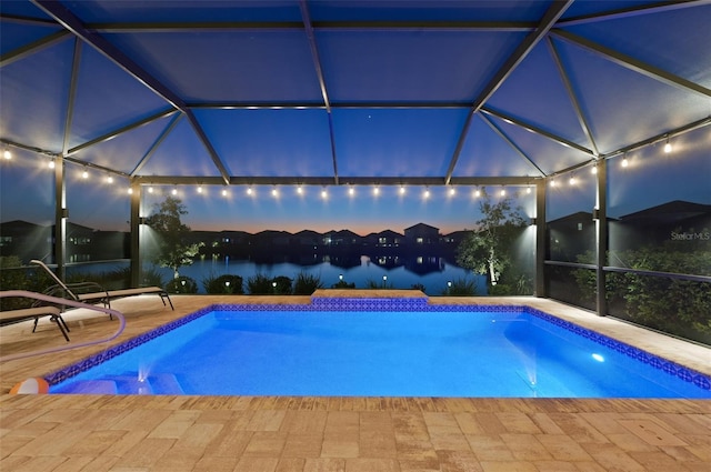 outdoor pool with a lanai and a patio area