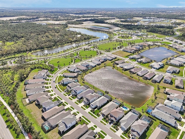 aerial view of property and surrounding area with a nearby body of water and nearby suburban area