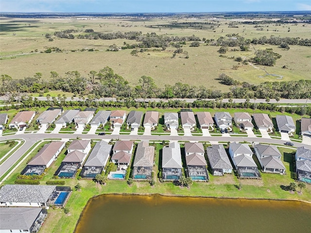 view of property location featuring a large body of water and nearby suburban area