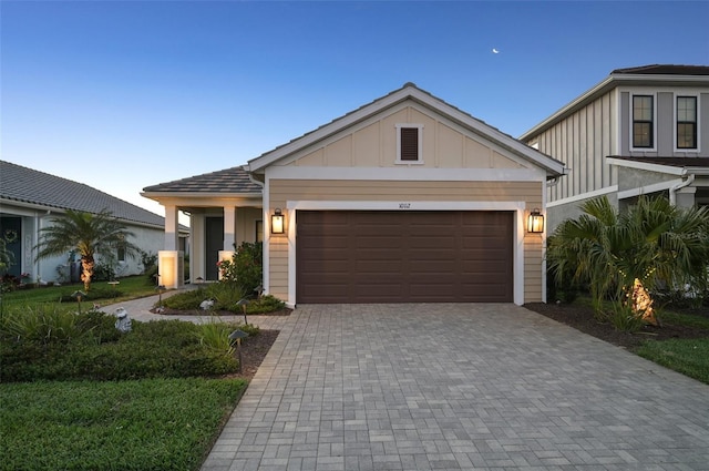 view of front of house with board and batten siding, a garage, and driveway
