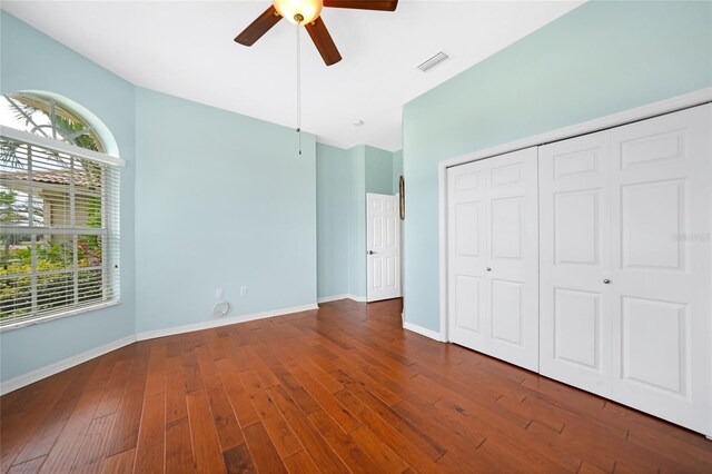 16531 San Edmundo Rd, Punta Gorda, FL 33955 - unfurnished bedroom featuring multiple windows, dark wood-type flooring, a closet, and baseboards