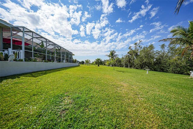 16531 San Edmundo Rd, Punta Gorda, FL 33955 - view of grassy yard with glass enclosure
