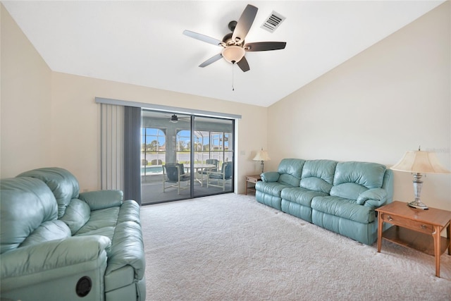 living area featuring lofted ceiling, carpet, visible vents, and a ceiling fan