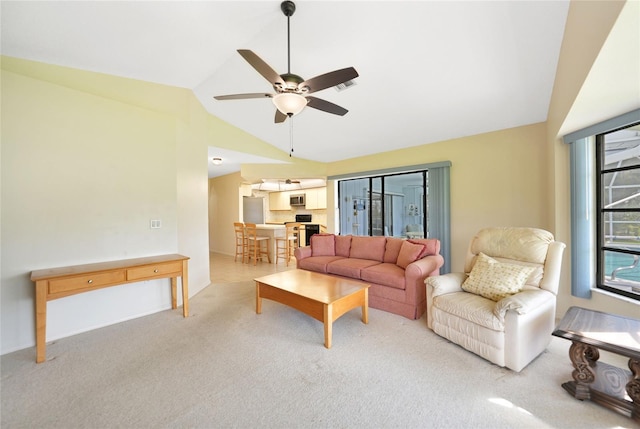 carpeted living room with lofted ceiling and a ceiling fan