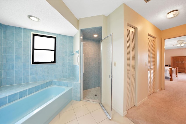 full bathroom featuring a stall shower, connected bathroom, tile patterned floors, a textured ceiling, and a closet