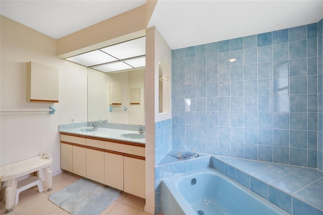 full bathroom featuring double vanity, a garden tub, tile patterned flooring, and a sink