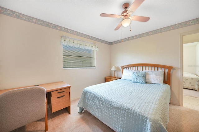 bedroom with light carpet, ceiling fan, and baseboards