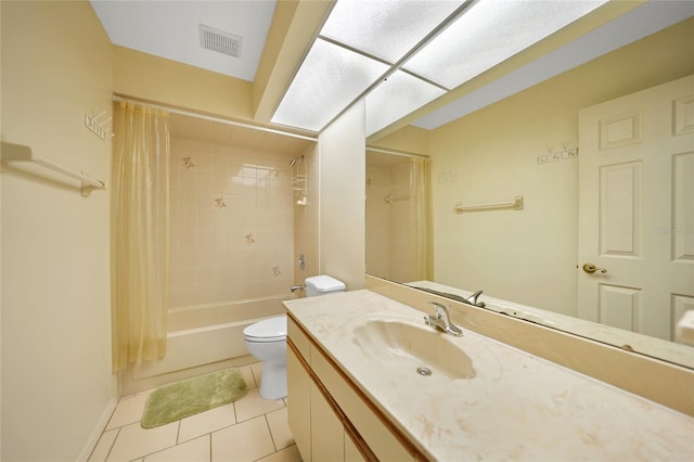 bathroom featuring toilet, vanity, visible vents, tile patterned floors, and shower / tub combo with curtain